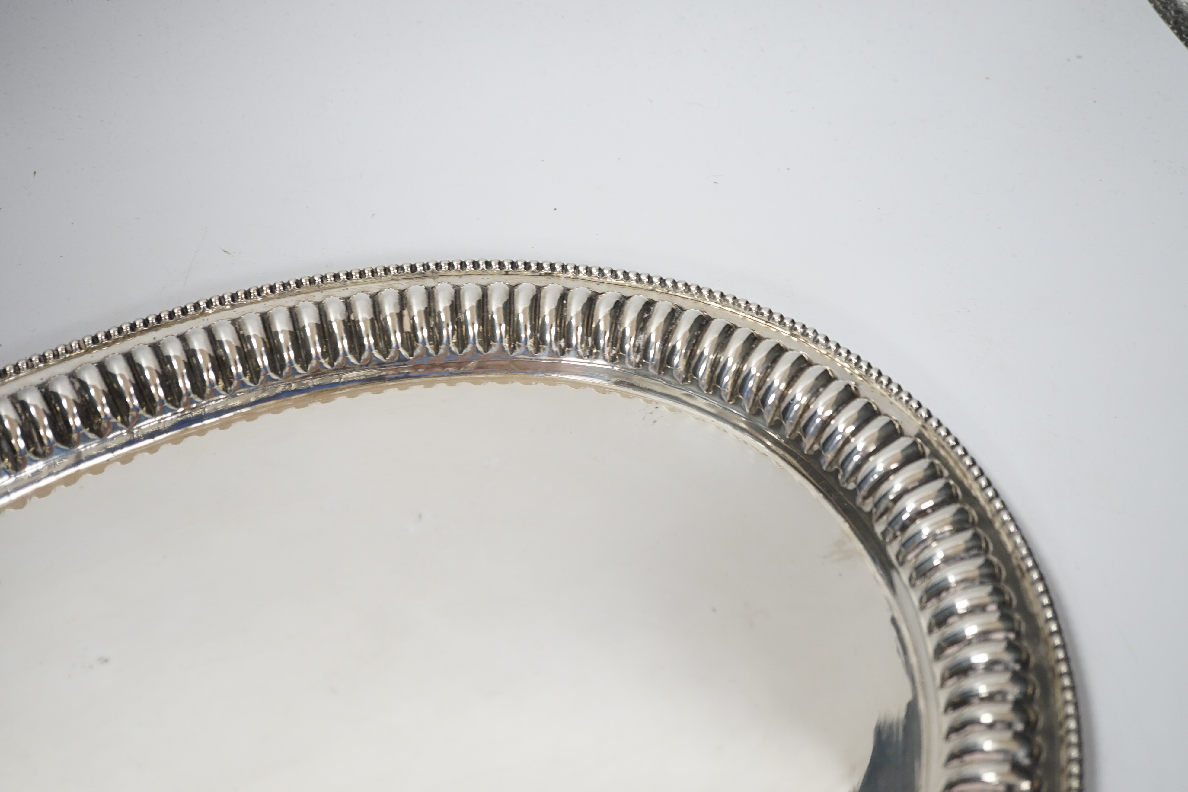 A Far Eastern white metal oval tray, with gadrooned and beaded rim, stamped silver, 45cm